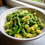 Close-up of Green goddess pasta salad featuring fusilli pasta, bright green asparagus spears, and creamy herb dressing.