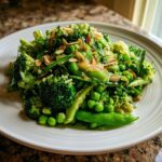 Close-up of a vibrant Lemony broccoli and sweet pea salad topped with slivered almonds.